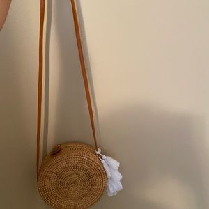 Wicker woven purse with tassel and snap button closing